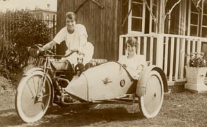 [woman riding motorcycle with sidecar]